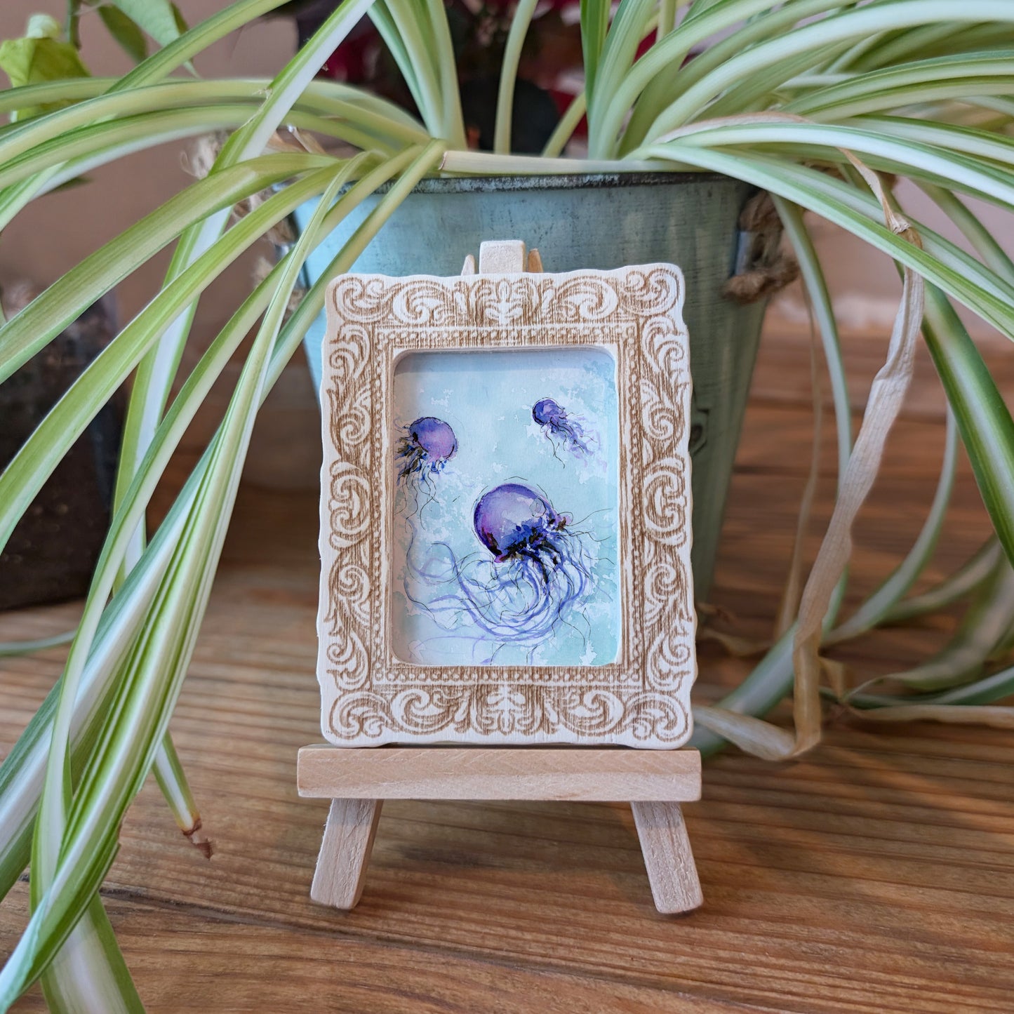 a small picture frame with a jellyfish on it