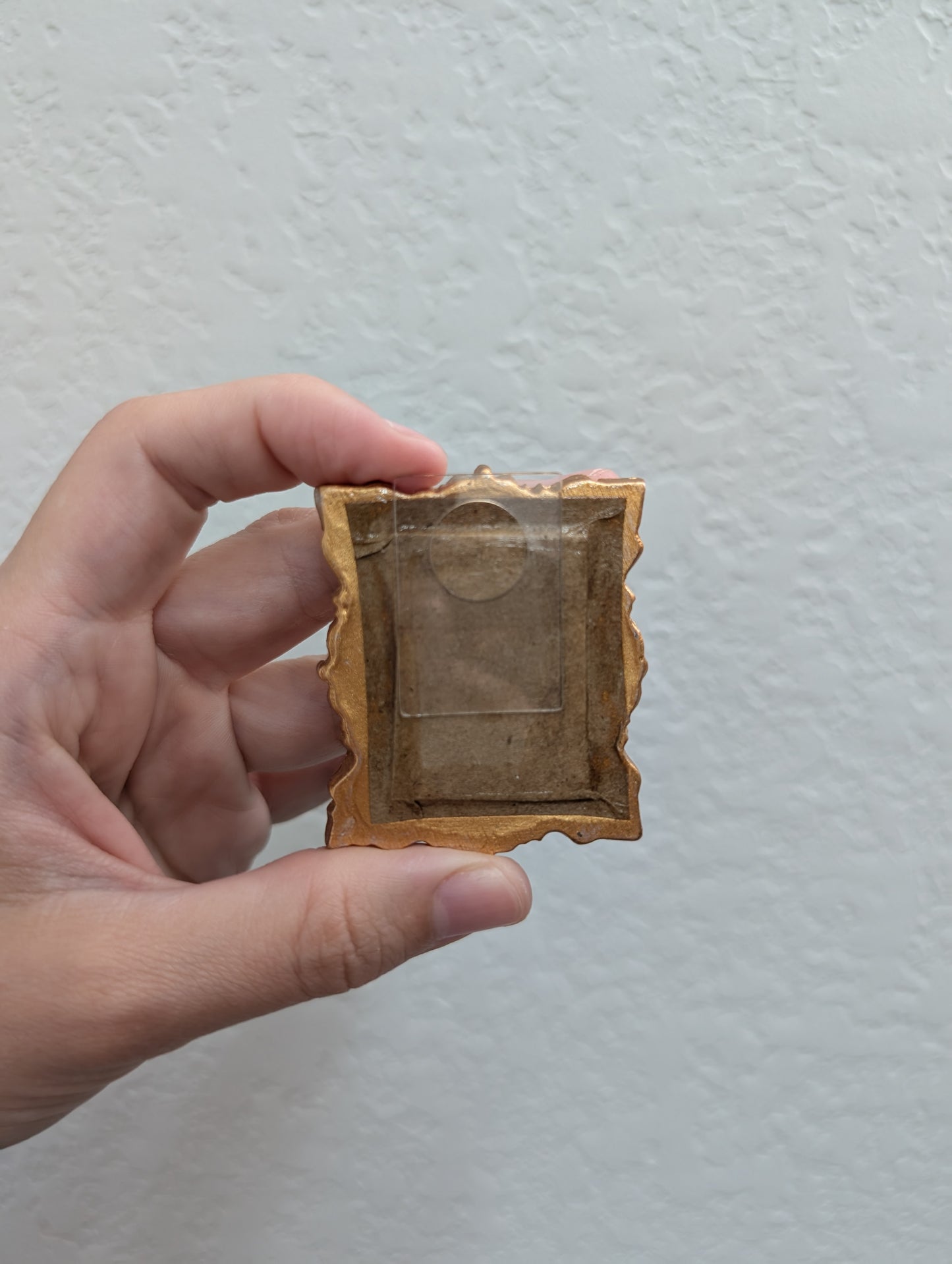 a person holding a small object in their hand
