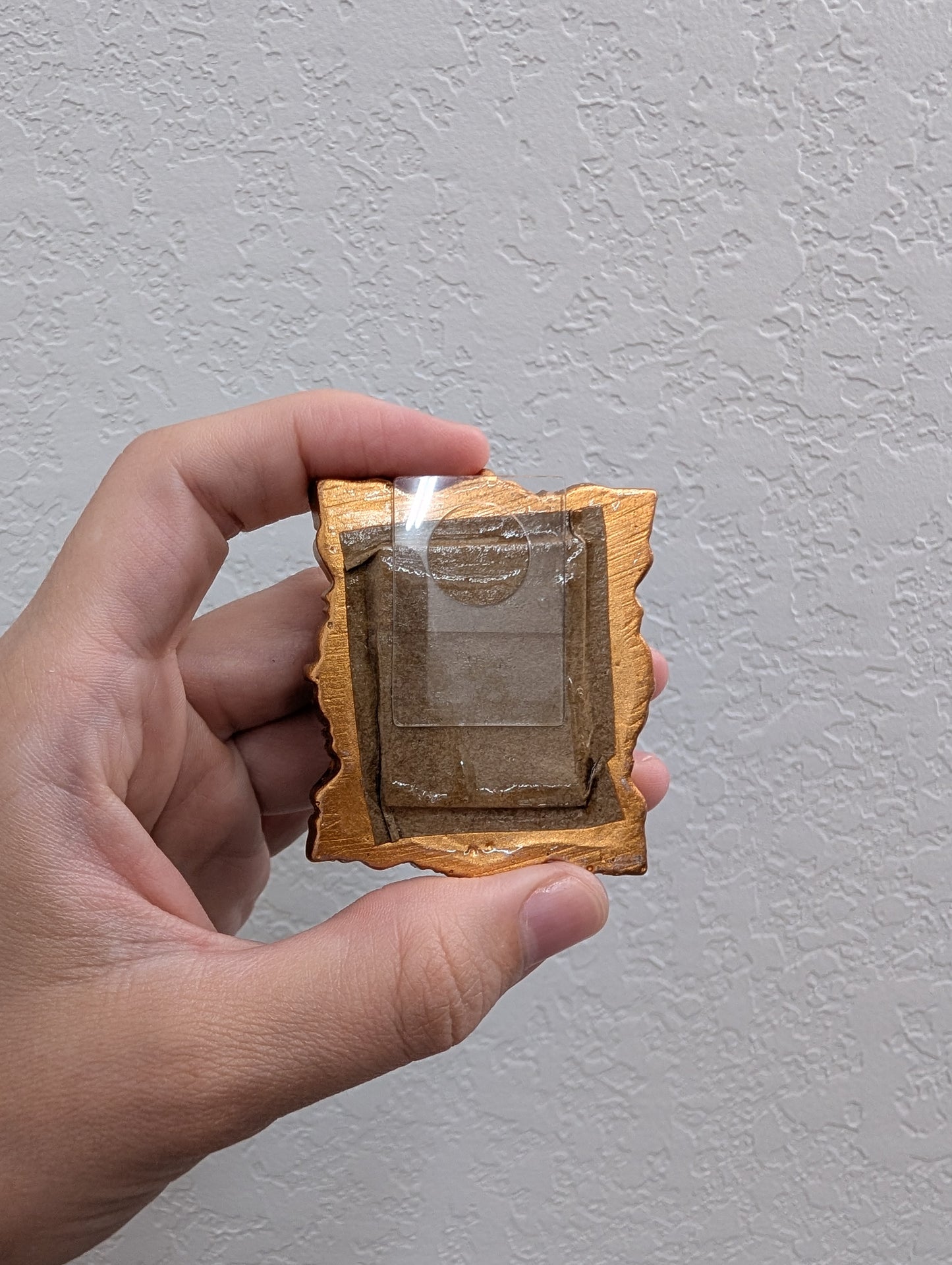 a person holding a small object in their hand