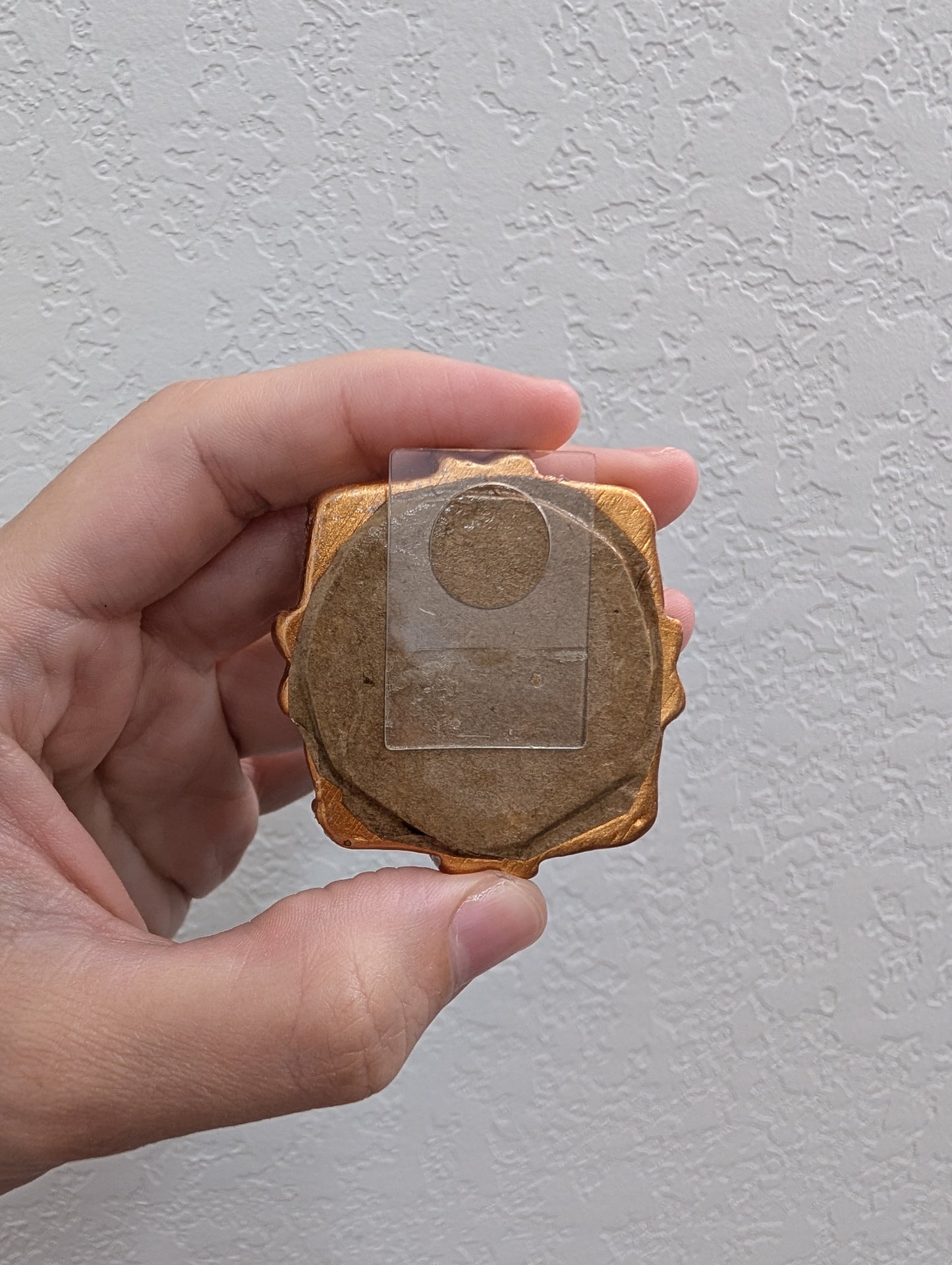 a person holding a piece of wood in their hand