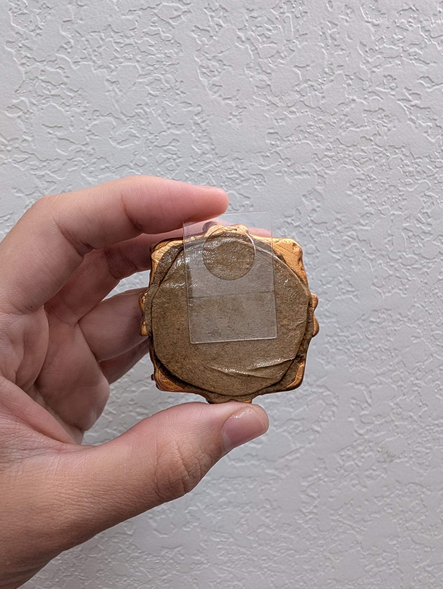 a person holding a piece of wood in their hand