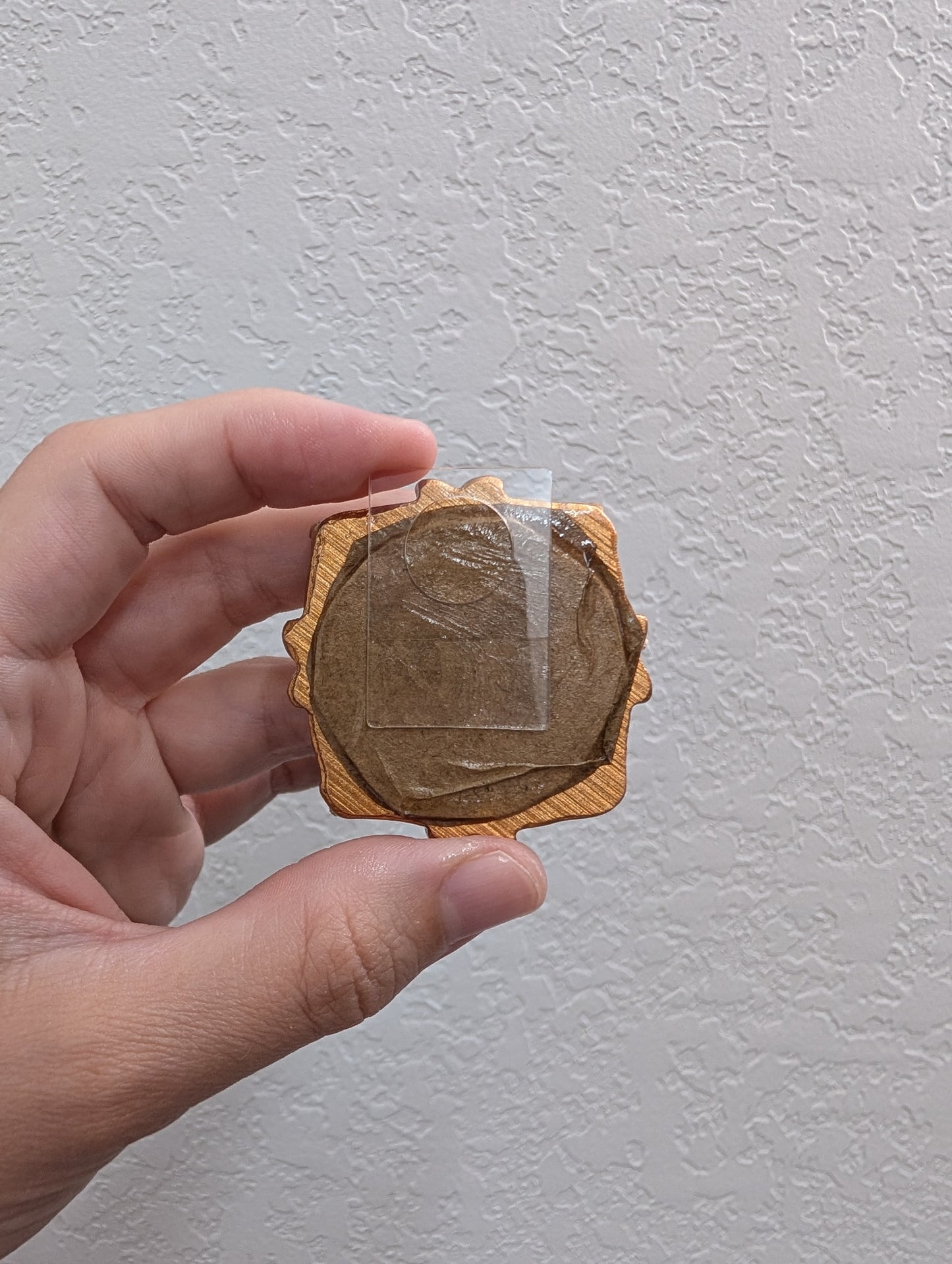 a person holding a piece of wood in their hand