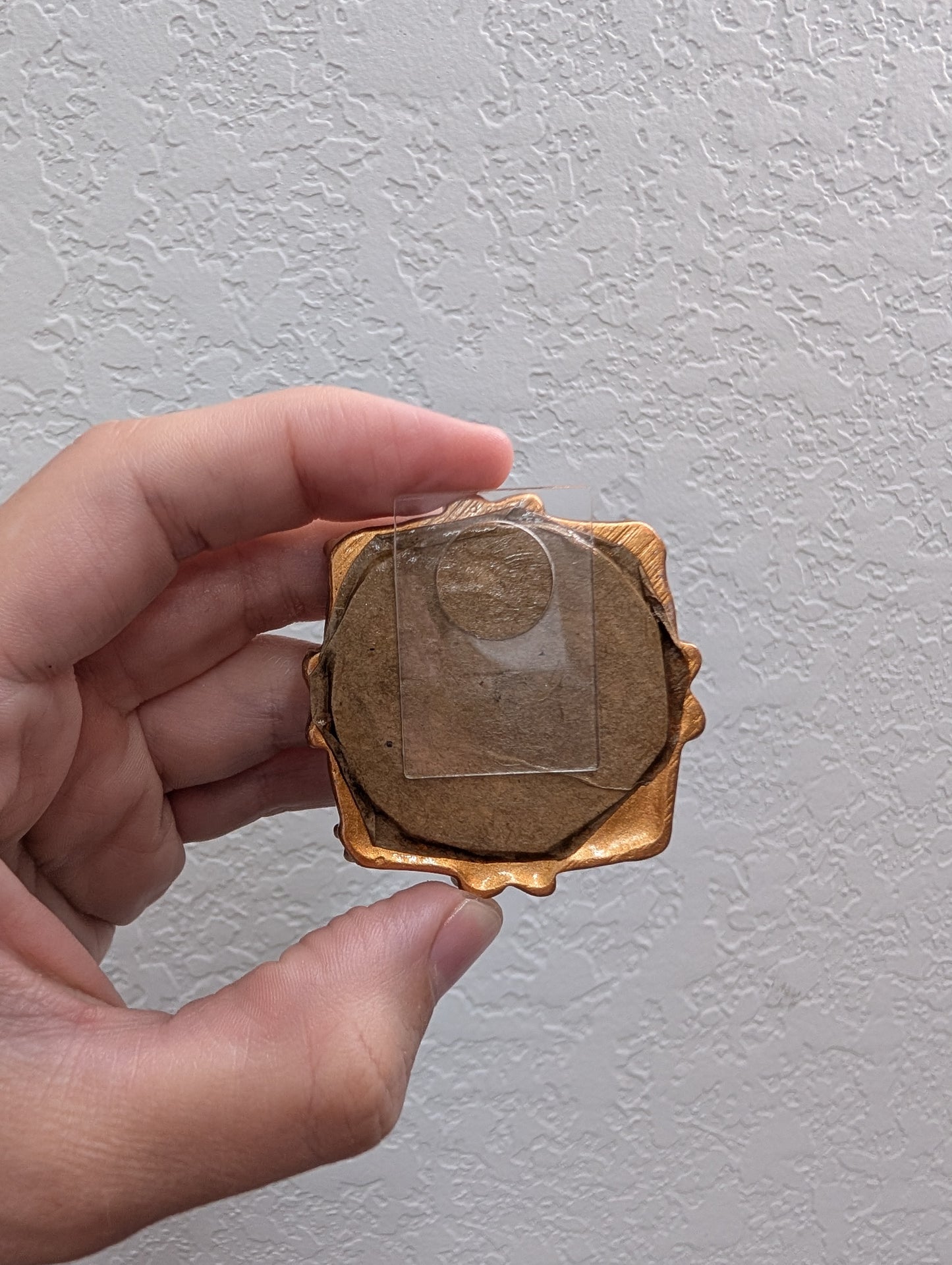 a person holding a piece of wood in their hand