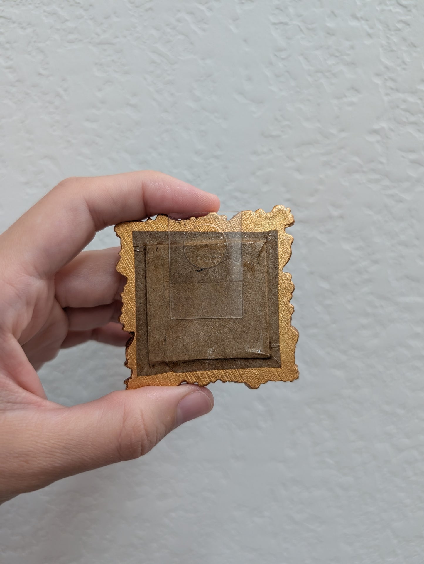 a person holding a small piece of paper in their hand