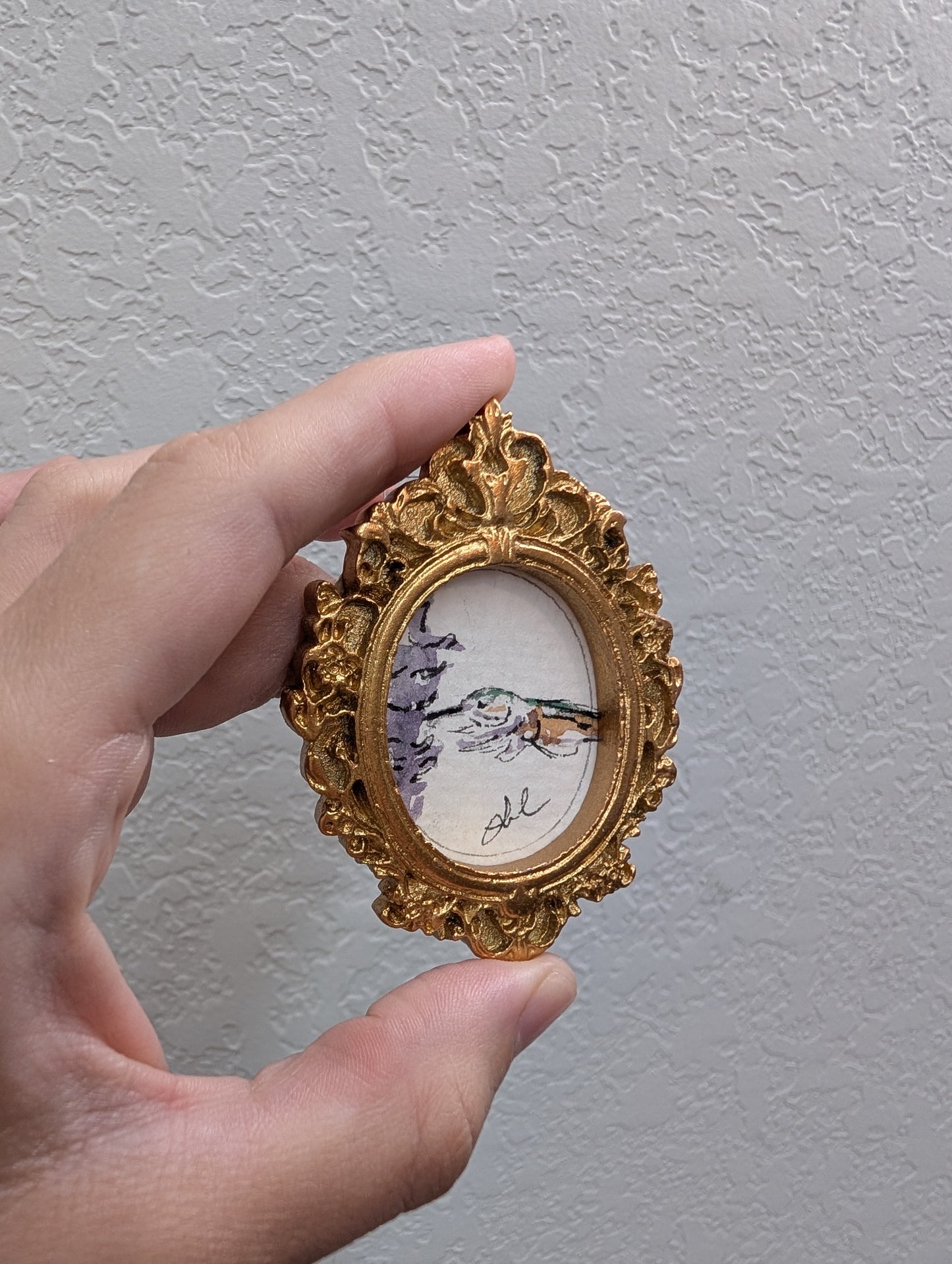 a person holding a small clock in their hand