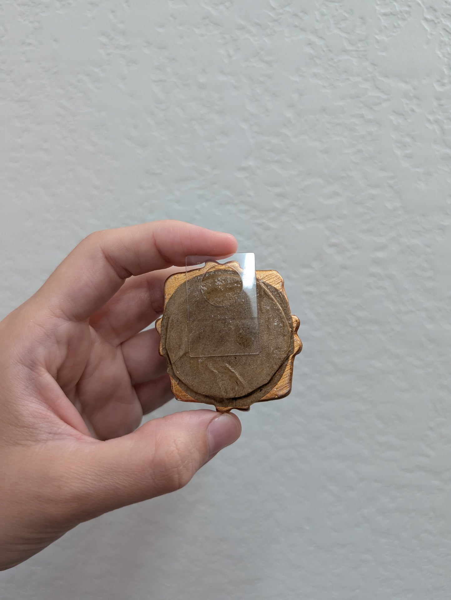 a person holding a piece of wood with a candle in it