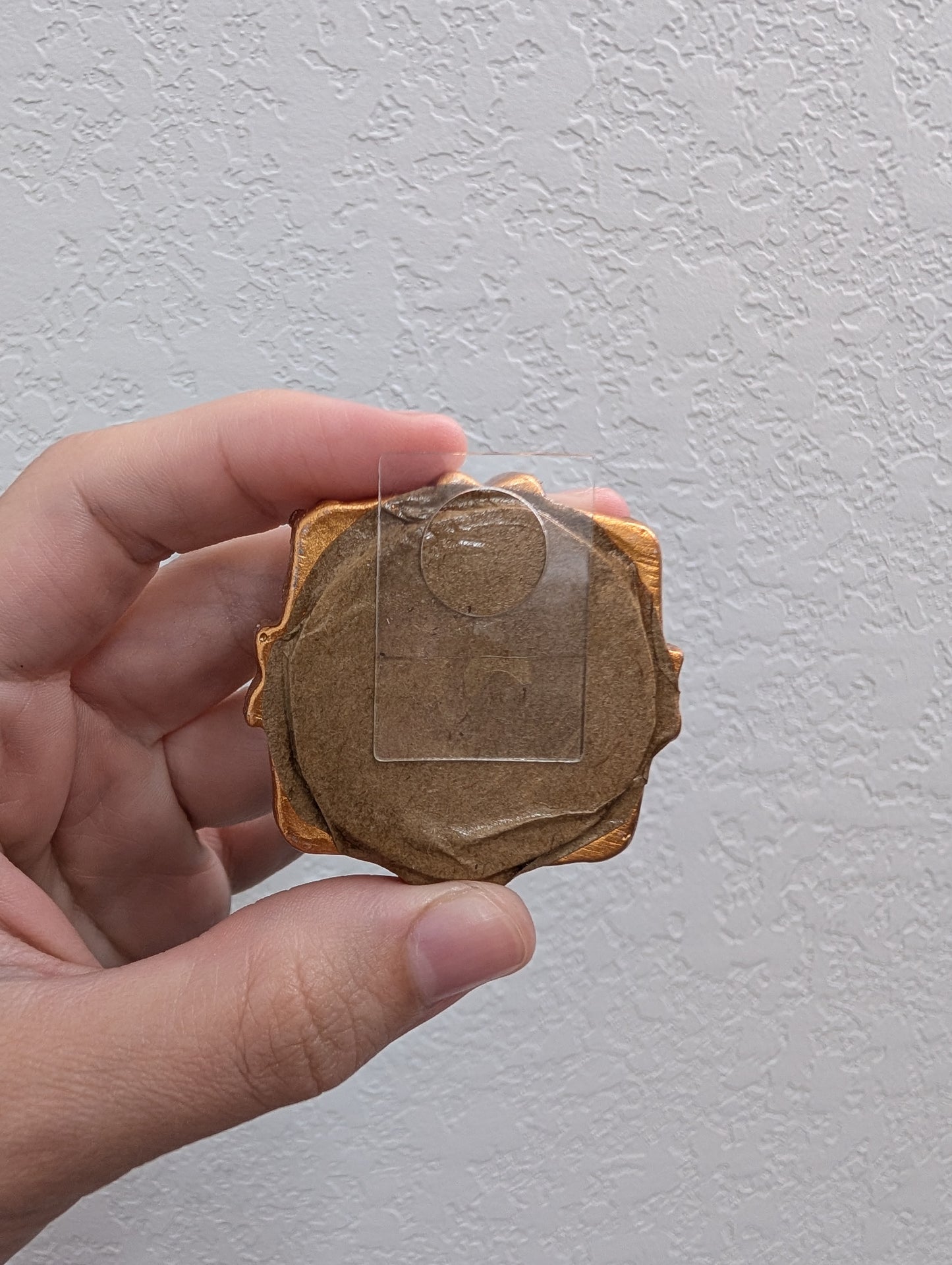 a person holding a piece of wood in their hand