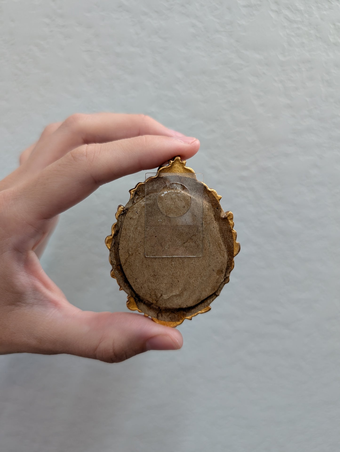 a person holding a piece of wood in their hand