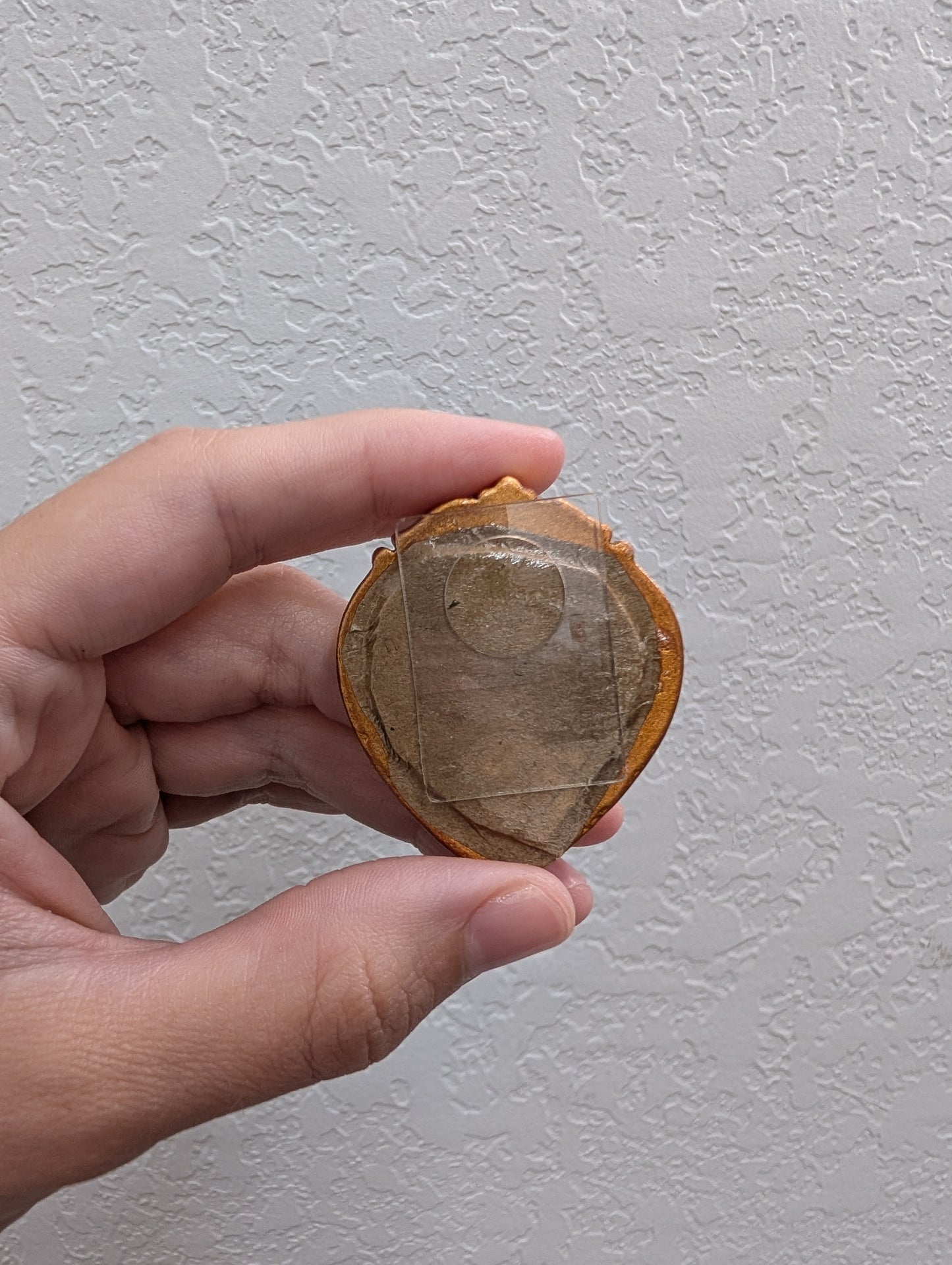 a person holding a piece of wood in their hand