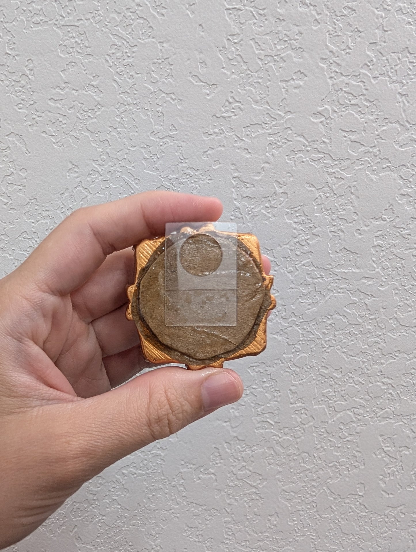 a person holding a piece of wood in their hand
