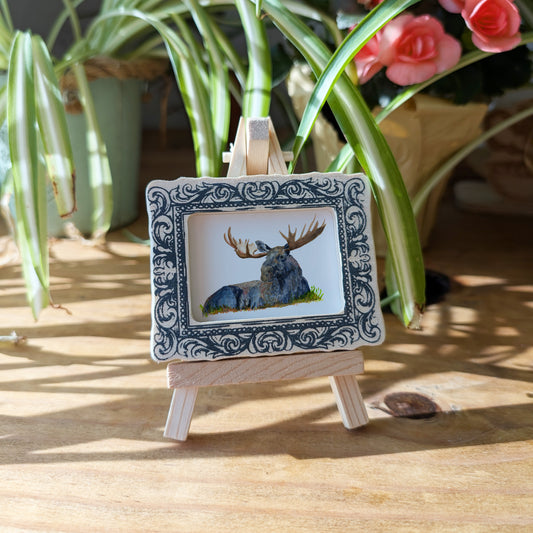 a picture of a deer on a wooden easel