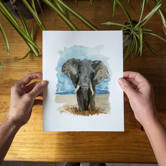 a person holding a card with a picture of an elephant