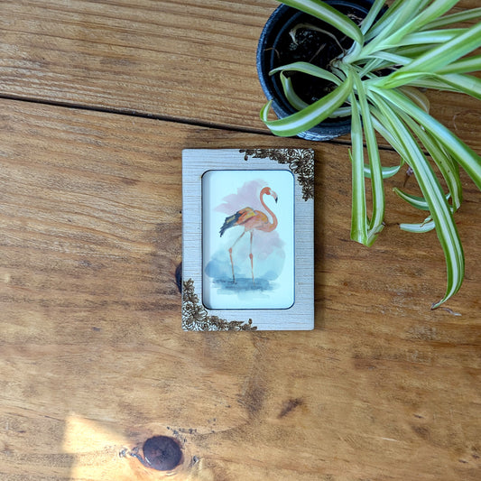 a picture of a pink flamingo on a wooden table