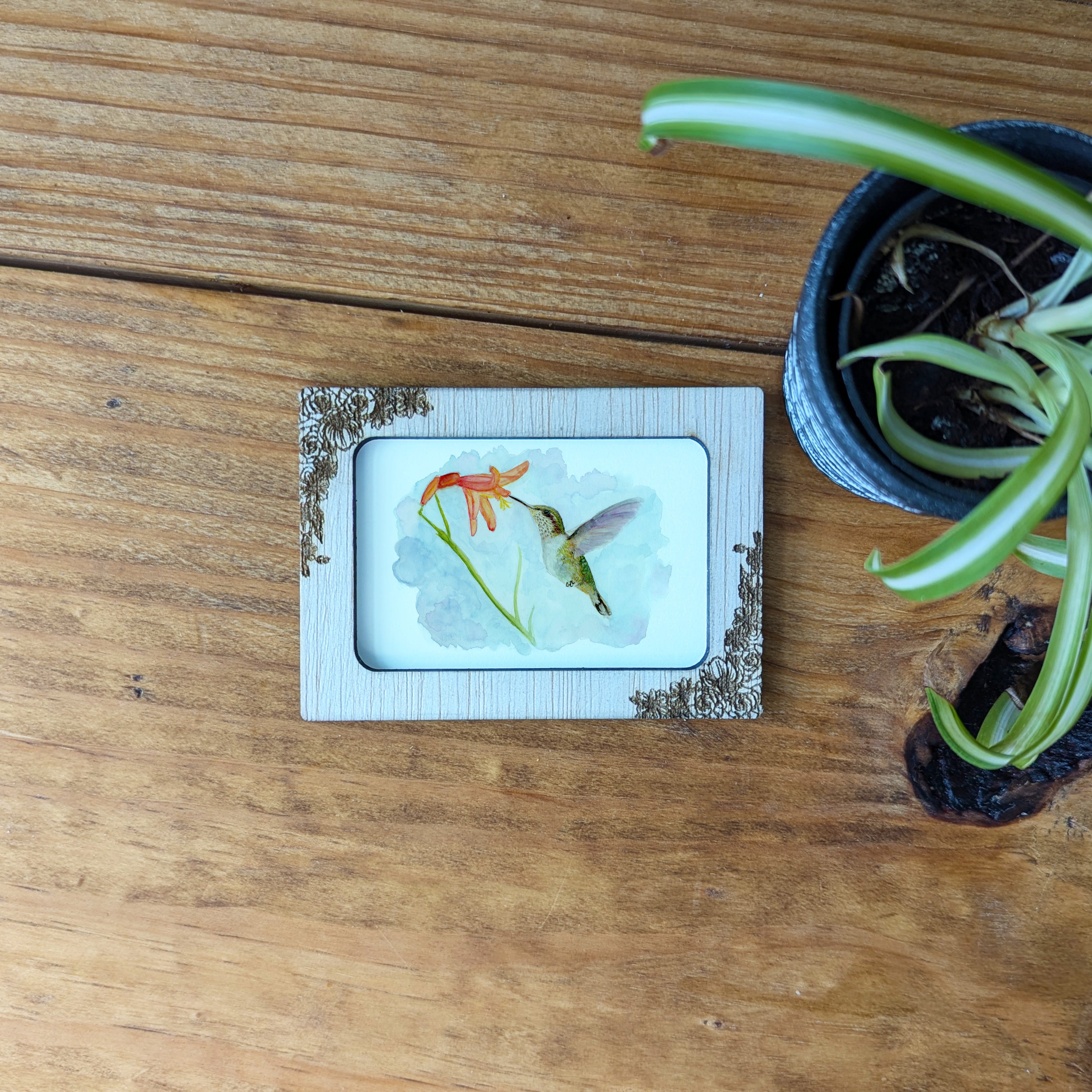 a picture of a flower on a wooden table