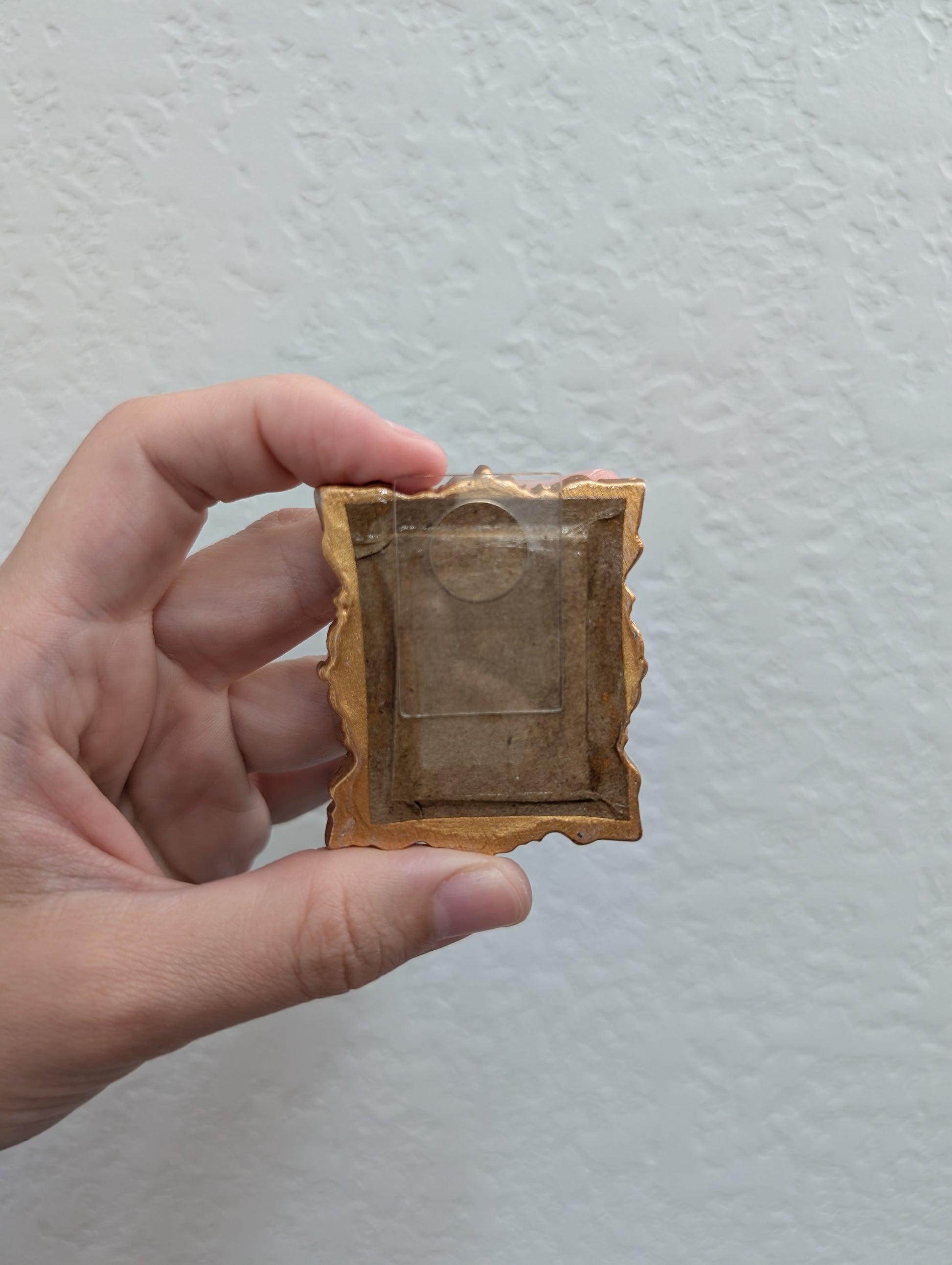 a person holding a small object in their hand
