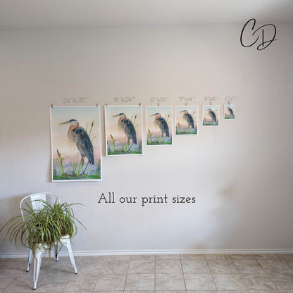 a white chair sitting in front of a wall with pictures on it