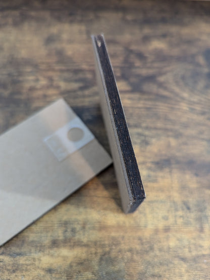 a piece of metal sitting on top of a wooden table