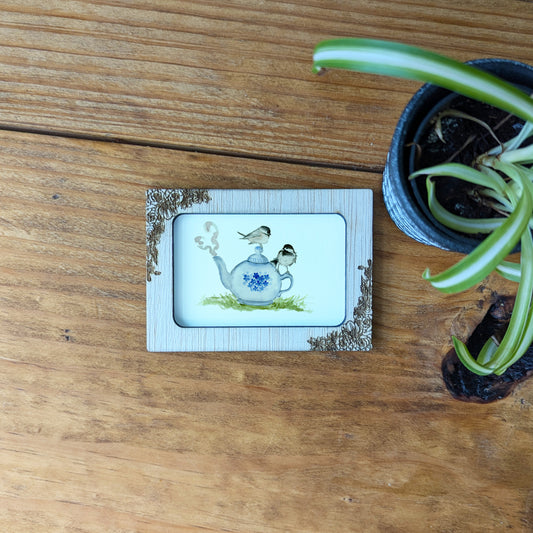 a picture of a potted plant on a wooden table