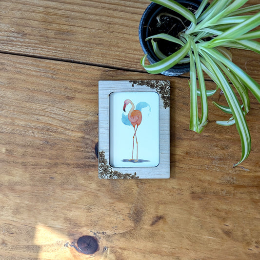 a picture of a bird on a wooden table