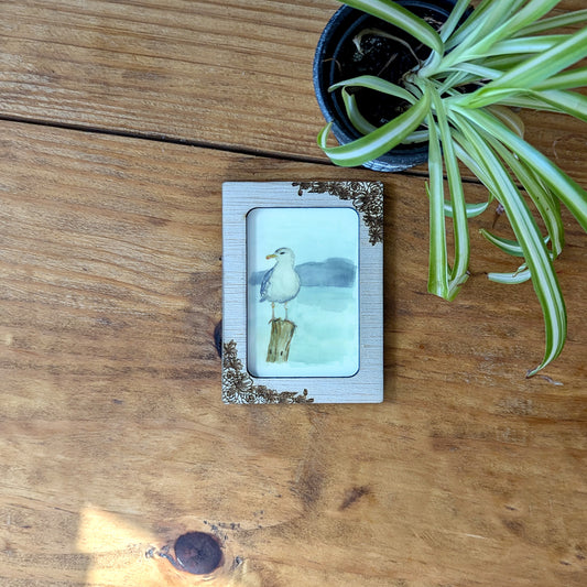 a picture of a seagull on a wooden table