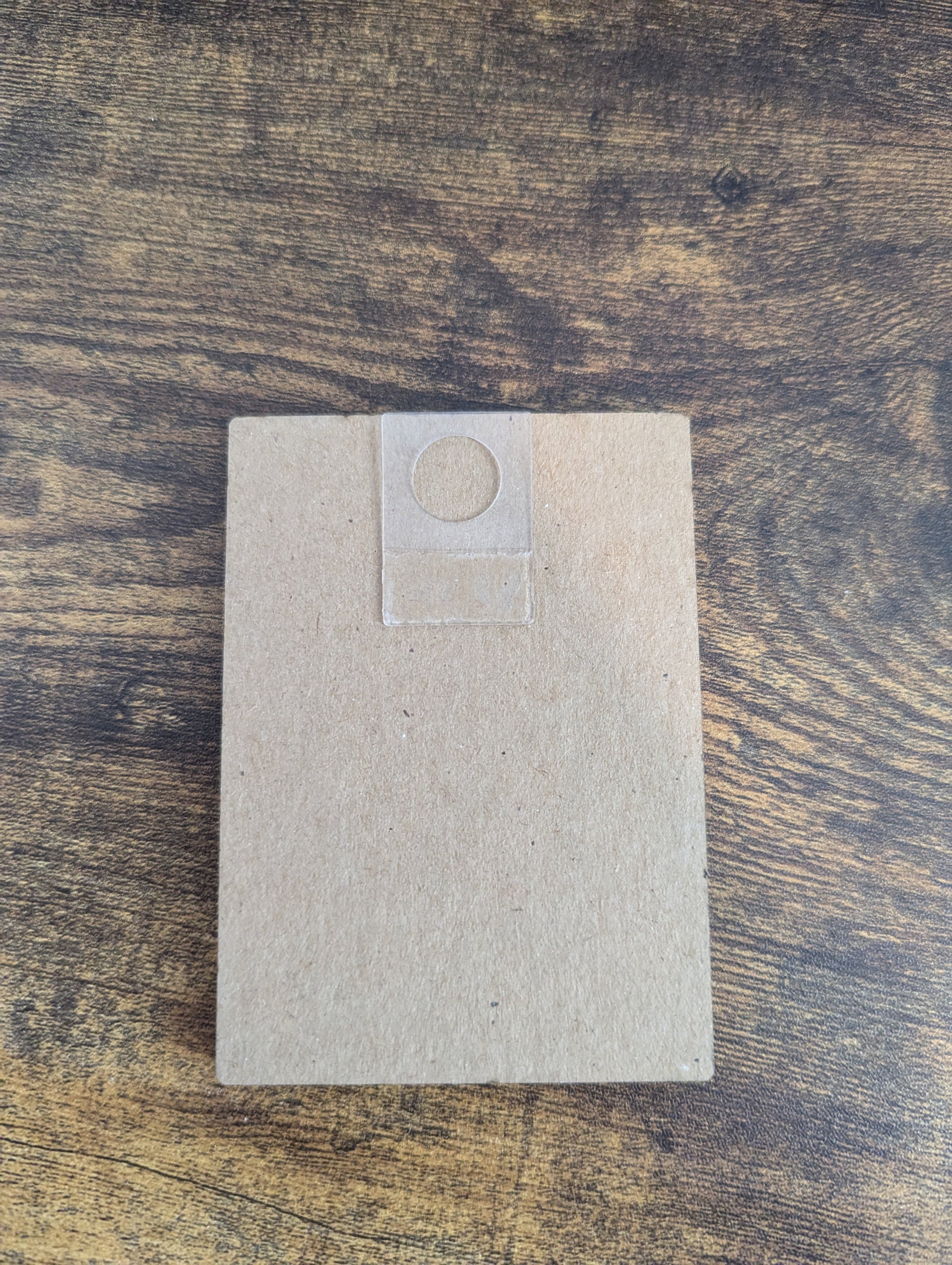 a square piece of paper sitting on top of a wooden table