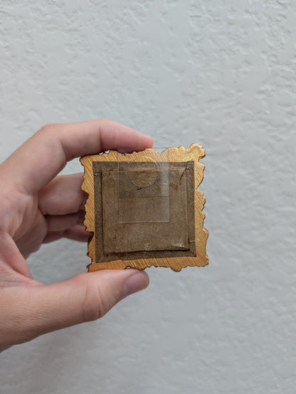 a person holding a small piece of paper in their hand