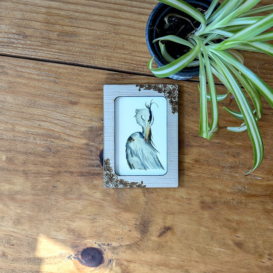 a picture of a bird on a wooden table