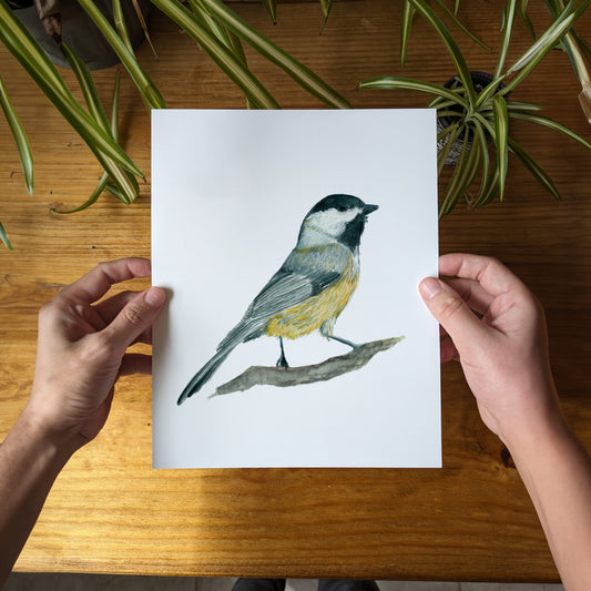 a person holding a card with a bird on it