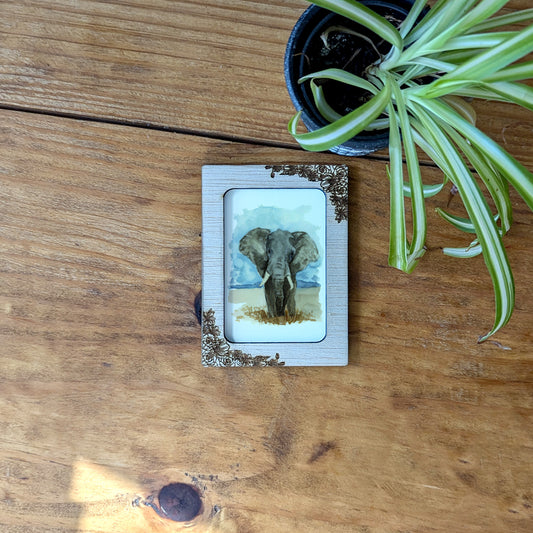 a picture of an elephant on a wooden table