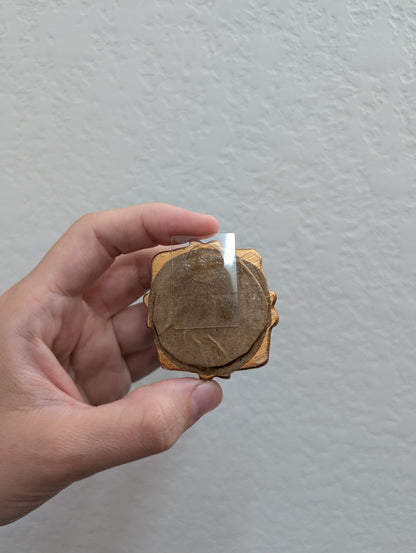 a person holding a piece of wood with a candle in it