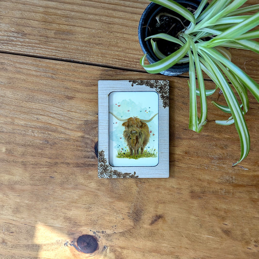 a small picture of a dog on a wooden table