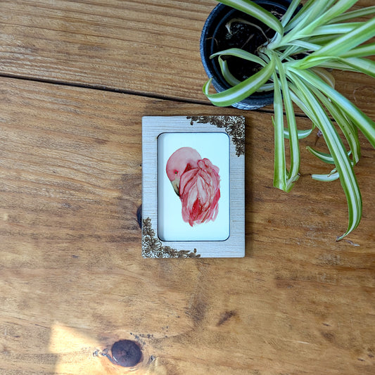 a picture of a flower on a wooden table