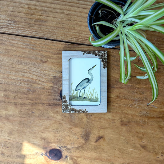 a picture of a bird on a wooden table