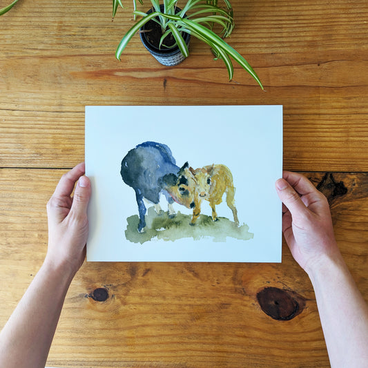 a person holding a card with a picture of two animals