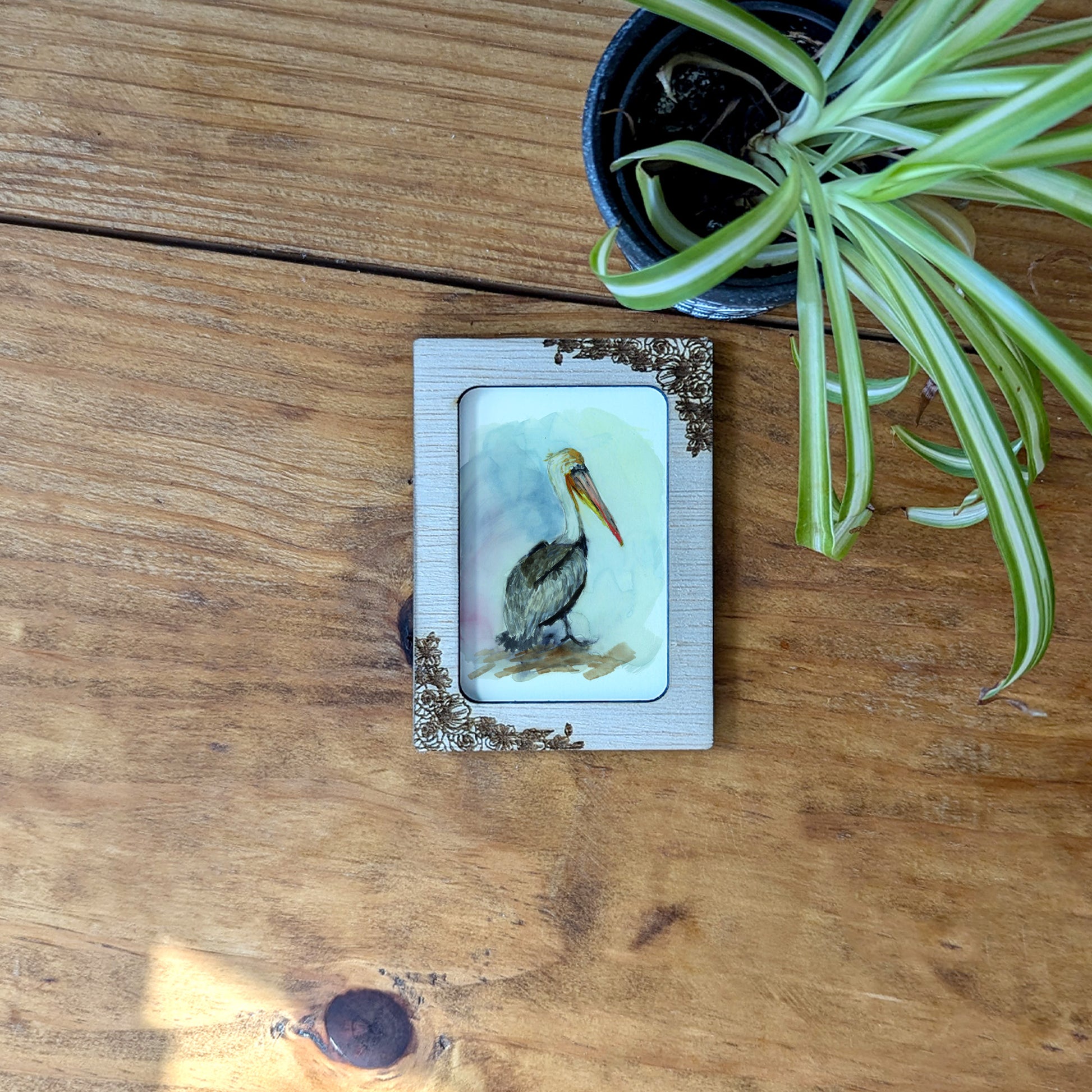 a picture of a bird on a wooden table