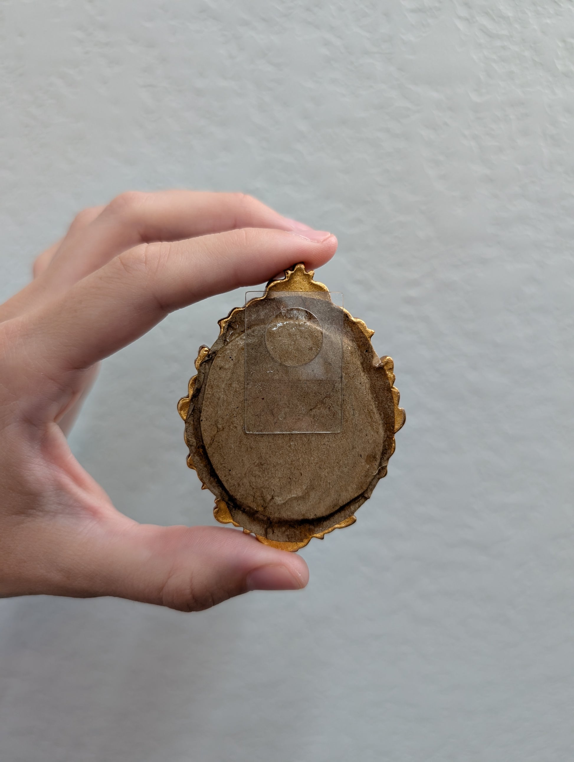 a person holding a piece of wood in their hand