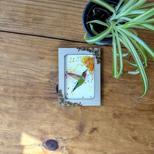 a picture of a bird on a wooden table