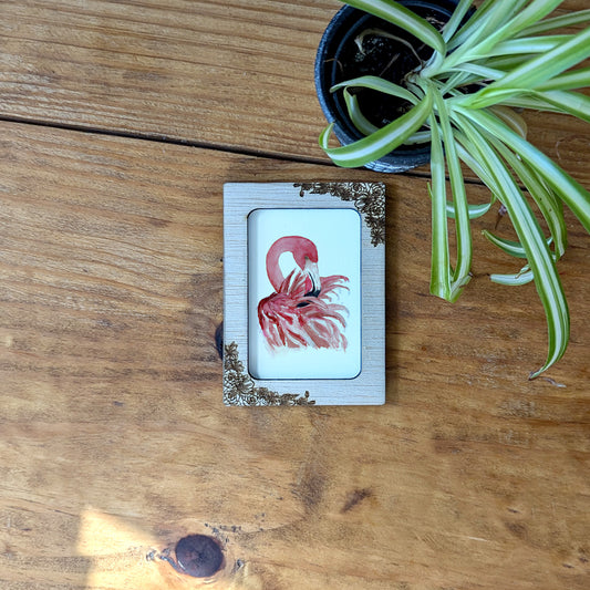 a picture of a flamingo on a wooden table