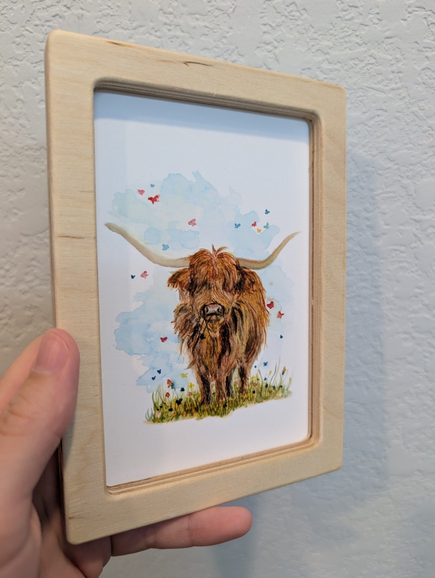 Highland Cow in Field with Butterflies Art Print - Solidframe Art by Lora Cavallin